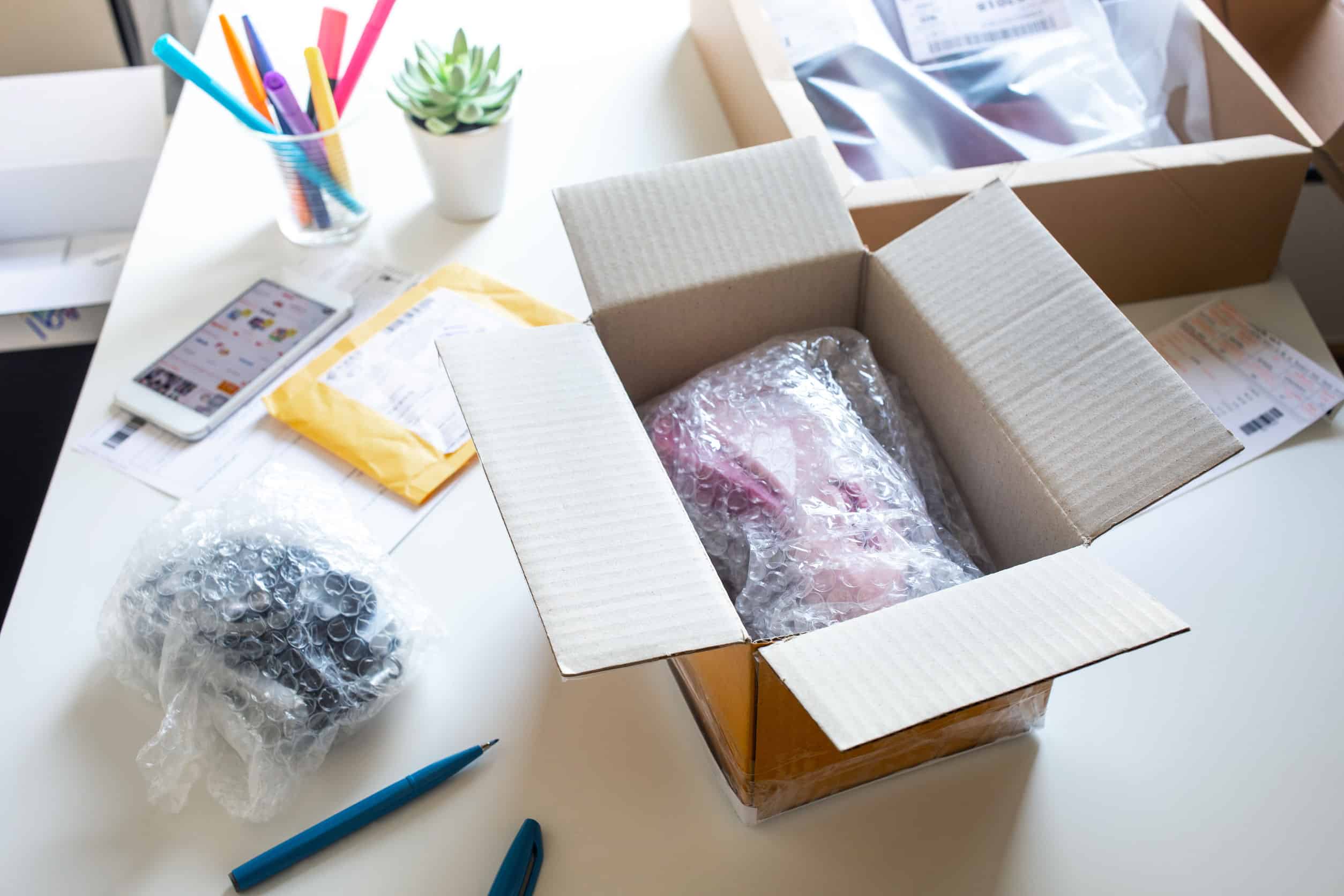 Online orders being packed into protective parcel boxes